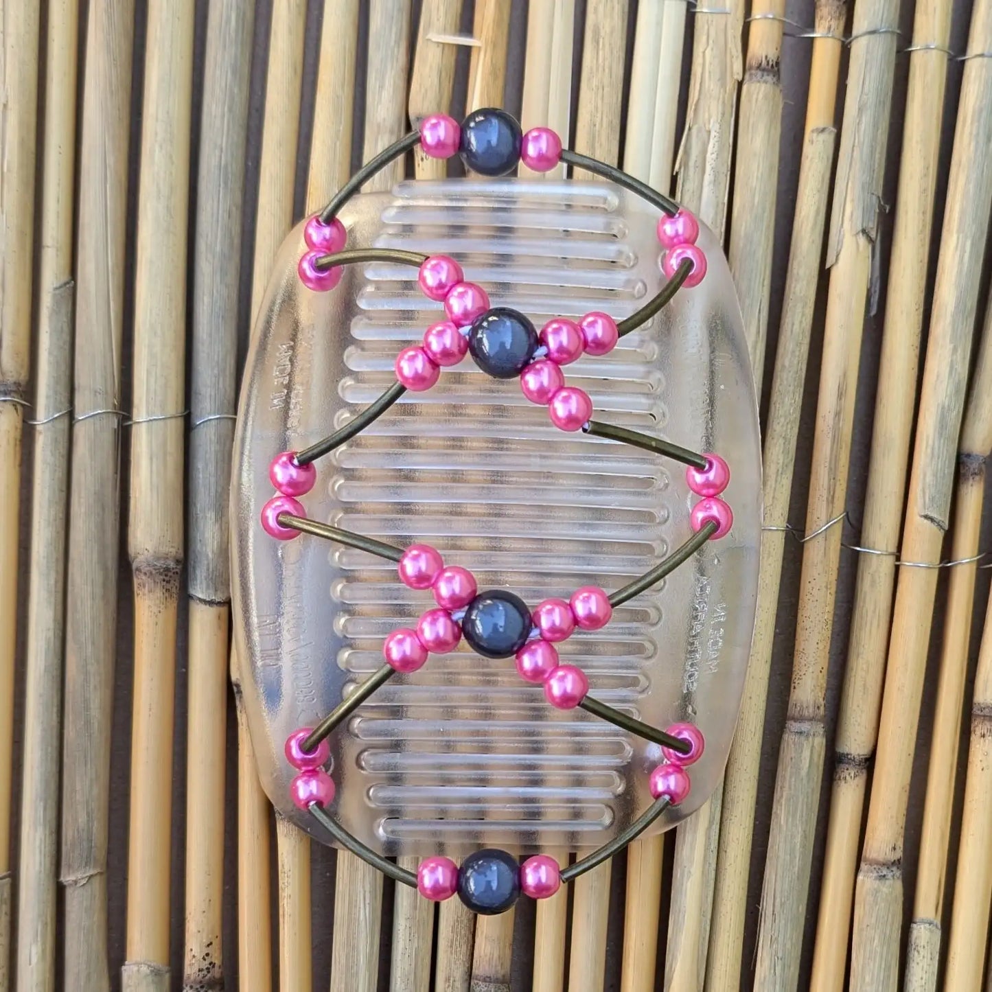 Durchsichtiger African Butterfly Haarkamm mit rosa und grauen Kunstperlen mit feinen Metallstäben - flexibler Haarschmuck für Hochsteckfrisuren.