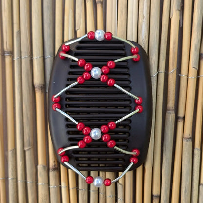 Schwarzer African Butterfly Haarkamm mit roten und weißen Kunstperlen mit feinen Metallstäben - flexibler Haarschmuck für Hochsteckfrisuren.